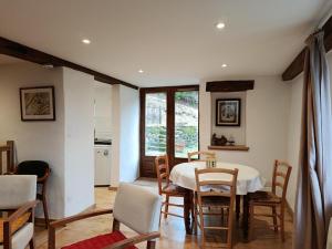 a dining room with a table and chairs at Le verger in Vébron +9 photos
