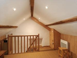 a room with a staircase in a house with wooden ceilings at Le verger in Vébron