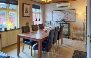 a dining room with a wooden table and chairs at 4 Bedroom Gorgeous Home In Stege in Stege