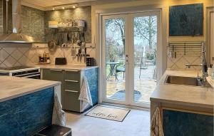 a kitchen with a sink and a door to a patio at 4 Bedroom Gorgeous Home In Stege in Stege