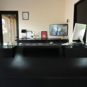 an office with a desk with a computer and a monitor at SUITES LOMBOY & PLAZA in San José del Cabo