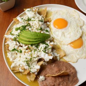 a plate of breakfast food with eggs and chips at SUITES LOMBOY & PLAZA in San José del Cabo +15 photos