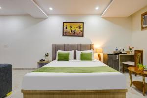 a bedroom with a large bed and a desk at Castle Grand Dwarka in New Delhi +54 photos