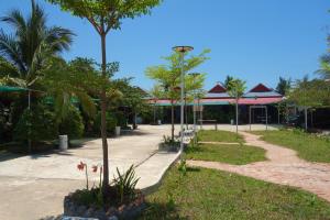 a park with trees and a building in the background at AHHA Bungalow Kampot in Kampot
