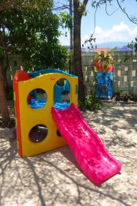 a childs play area with a pair of red rubber boots at AHHA Bungalow Kampot in Kampot
