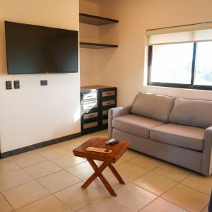 a living room with a couch and a coffee table at SUITES LOMBOY & PLAZA in San José del Cabo