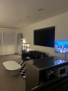a living room with a couch and a flat screen tv at momohouse 체스룸 in Chinyŏng-yŏk