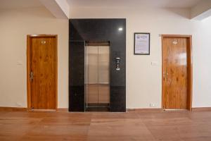 a hallway with two wooden doors in a room at Treebo Melag Jispa With Mountain View in Jispa +40 photos