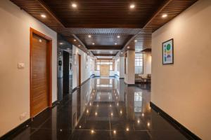 a hallway of a building with lights on the floor at Treebo Melag Jispa With Mountain View in Jispa
