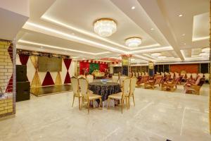 a large banquet hall with a table and chairs at Castle Grand Dwarka in New Delhi
