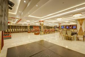 a banquet hall with tables and chairs in a room at Castle Grand Dwarka in New Delhi