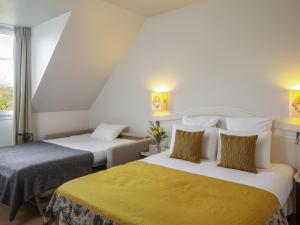 a hotel room with two beds and a window at Mercure Rambouillet Relays Du Château in Rambouillet +98 photos