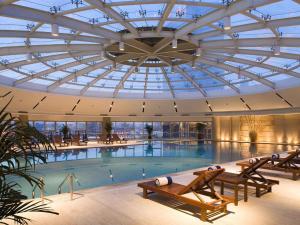 a large swimming pool with a glass ceiling at Sofitel Nanjing Galaxy Suning in Nanjing