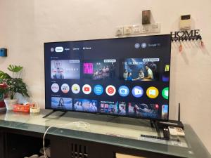 a large flat screen tv sitting on top of a table at LittleBee Homestay KT in Kota Tinggi