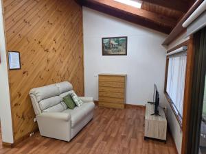 a living room with a couch and a television at BIG4 Sale Caravan Park in Sale