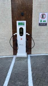 a gas pump sitting in front of a building at Flat Macambira Home Service in Campina Grande