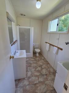 a bathroom with a shower and a sink and a toilet at BIG4 Sale Caravan Park in Sale +38 photos