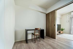 a room with a desk and a chair and a door at Formosa Hills in Kumamoto +20 photos