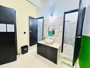 a bathroom with a sink and a shower at Hostal Pakal King in Palenque +44 photos