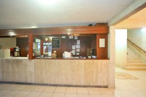 a restaurant with a counter in a building at Hotel del Principado Durango in Durango