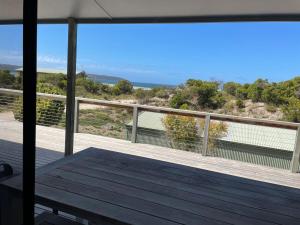 a balcony with a view of the ocean at Ocean Whisper in Island Beach +5 photos