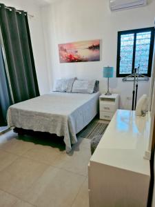 a bedroom with a bed and a table with a lamp at casa estefania in San Carlos +13 photos