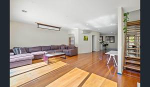 a living room with a couch and a table at Convenience & Luxury Apartment in Melbourne