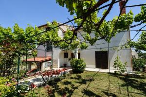 a house with a garden in front of it at Four-Bedroom Apartment in Stinjan I in Štinjan