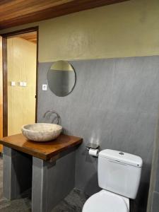 a bathroom with a sink and a toilet at The Sunrise Point in Katiet