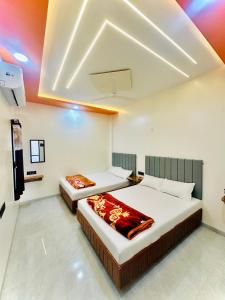 a bedroom with two beds in a room at Shiv Guest house in Ellora