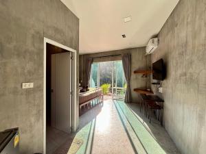 a hallway with a room with a large window at BAAN APA ERAWAN Resort in Ban Pong Pat