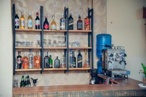 a shelf filled with lots of bottles of alcohol at Hotel KR Mandap in Pokhara +76 photos