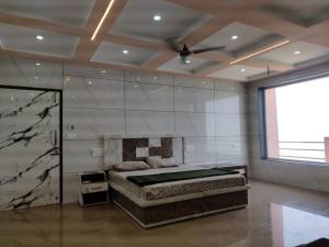 a bedroom with a bed and a ceiling fan at Pamma hotel in Anandpur Sāhib +8 photos