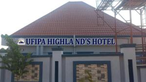 a building with a sign on top of it at Ufipa Highland's Hotel in Sumbawanga