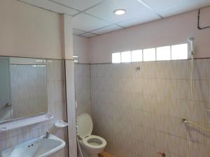 a bathroom with a toilet and a sink at 057 รีสอร์ท in Ban Huai To