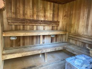 an empty wooden bench in a sauna at Seashells - 3BR Marcoola Beach Resort in Marcoola