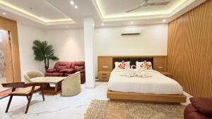 a bedroom with a bed with two cats on it at Orchha River Stone Resort in Orchha