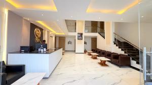 a lobby of a hotel with a reception desk and chairs at Orchha River Stone Resort in Orchha