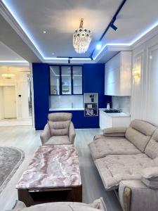 a living room with a couch and a table at Boulevard in Samarkand +1 photo