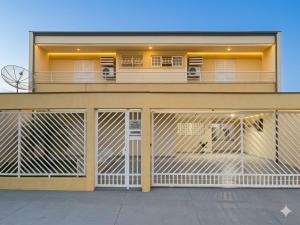 a building with two garage doors in front of it at Londrina Hostel Il in Londrina