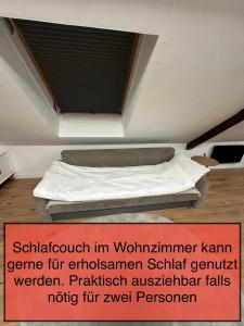 a bed in a room with a sign on the wall at Haus Lilium-Gemütliche Dachgeschoss Wohnung in Freudenstadt