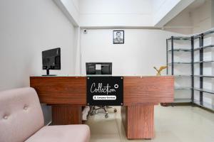 a office with a desk with a sign on it at Super OYO Collection O Prayag Railway Junction in Colonelganj