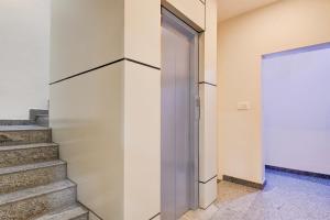 an open door in a building with stairs at Super Hotel O Mysore Zoological Park Formerly Queens Comfort in Mysore