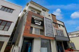 a building with a hilto sign on it at Super Hotel O Mysore Zoological Park Formerly Queens Comfort in Mysore +37 photos