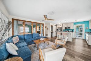 a living room with a blue couch and a table at 111 S Atlantic Ave in Cocoa Beach