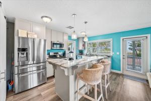 a kitchen with blue walls and stainless steel appliances at 111 S Atlantic Ave in Cocoa Beach