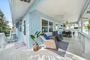 a porch with wicker chairs and a blue wall at 111 S Atlantic Ave in Cocoa Beach +54 photos