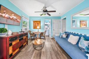 a living room with a blue couch and a table at 111 S Atlantic Ave in Cocoa Beach