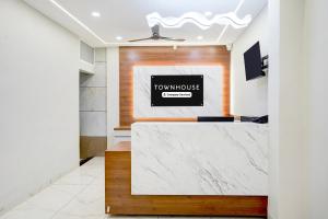 a view of a lobby with a white marble counter at Super Townhouse Rajendra Nagar Main Road in Indore