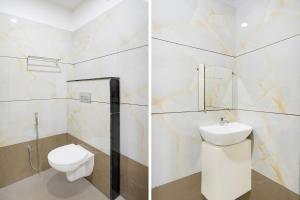 a bathroom with a toilet and a sink at Super Townhouse Rajendra Nagar Main Road in Indore